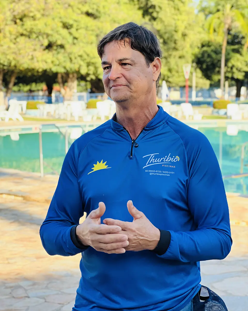 Thuríbio de uniforme, cuidando de uma piscina